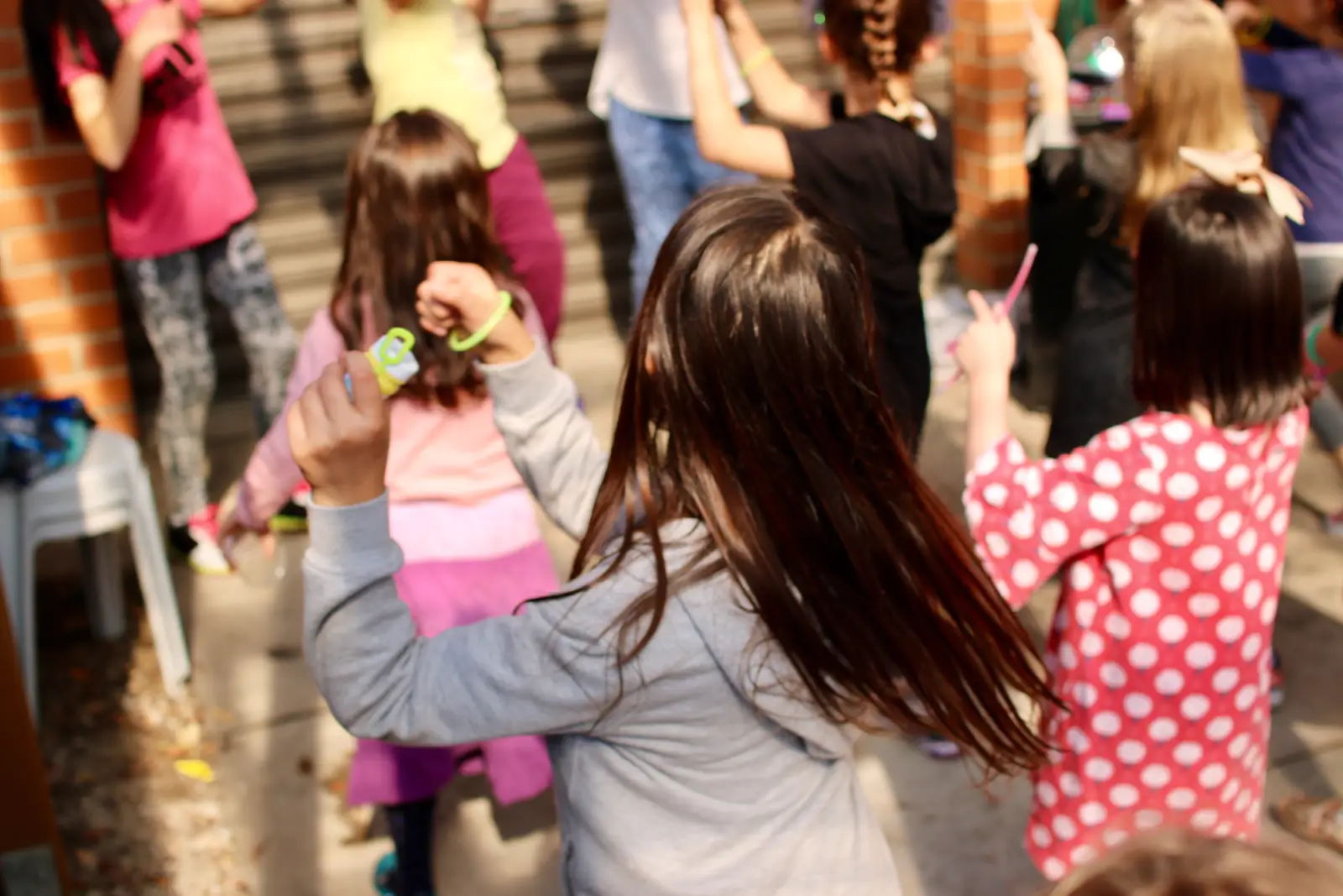 Children playing together with bubbles