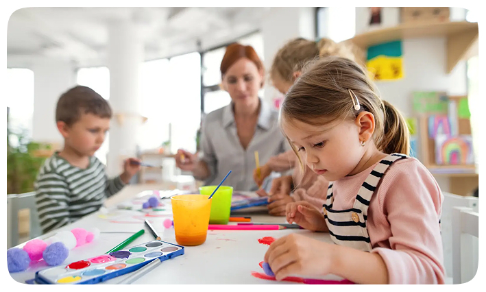 Children doing arts and crafts with a teacher
