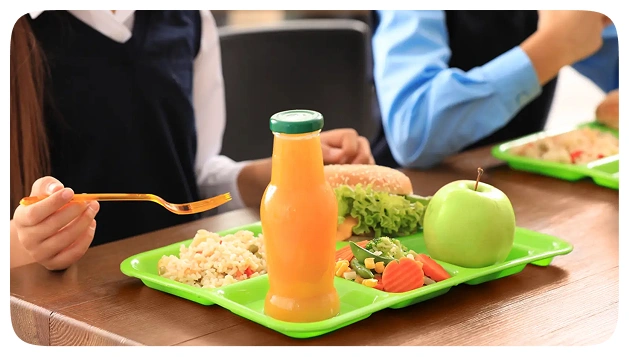 Lunch tray with vegetables, fruit, and juice